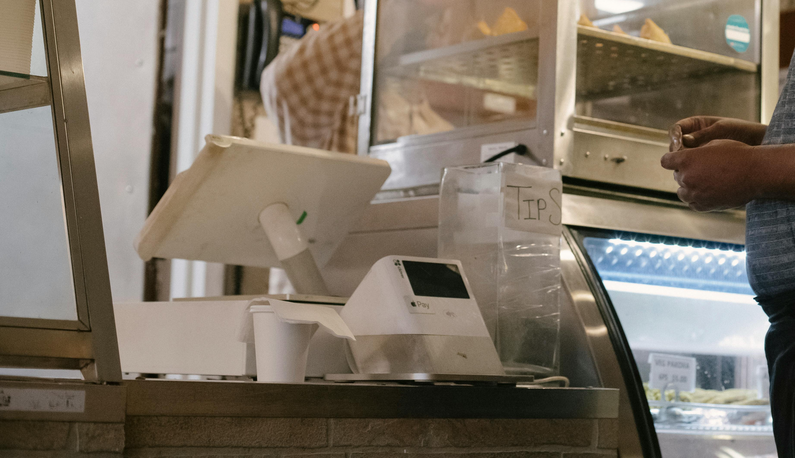 A bakery cash register with Apple Pay and a tip jar, representing a real-world business project created using the GRASPS model for authentic tasks.