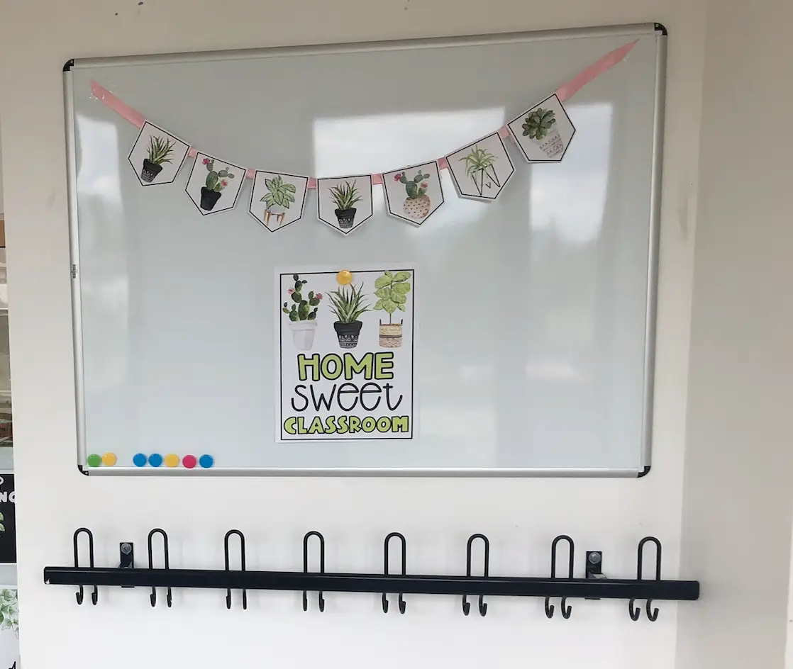 Setting up the classroom is an important part of the back-to-school teacher checklist. Board outside of classroom is decorated with a sign that says Home Sweet Classroom.