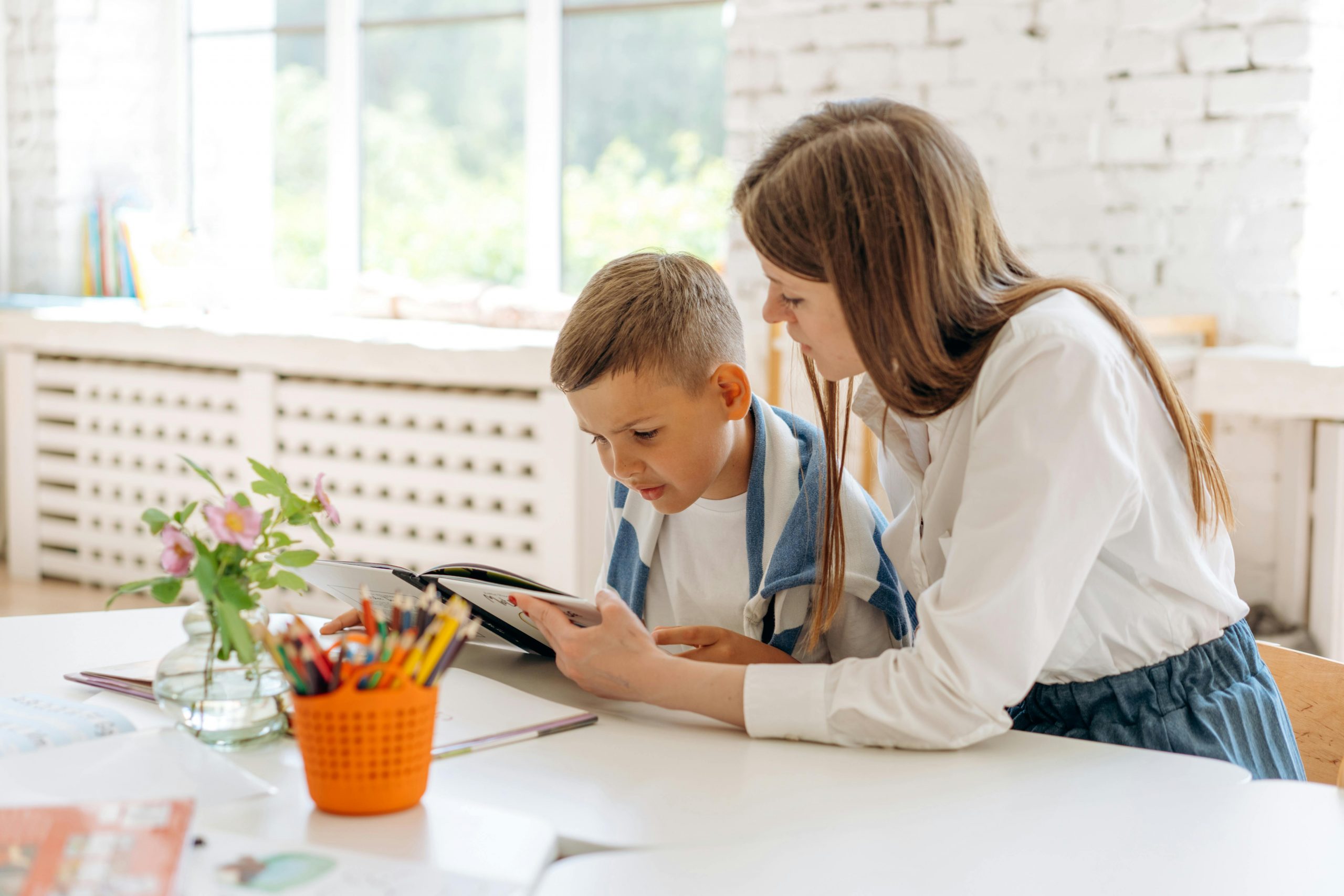 Teacher supporting a young student struggling with reading, emphasizing the importance of building relationships during the first year of teaching.