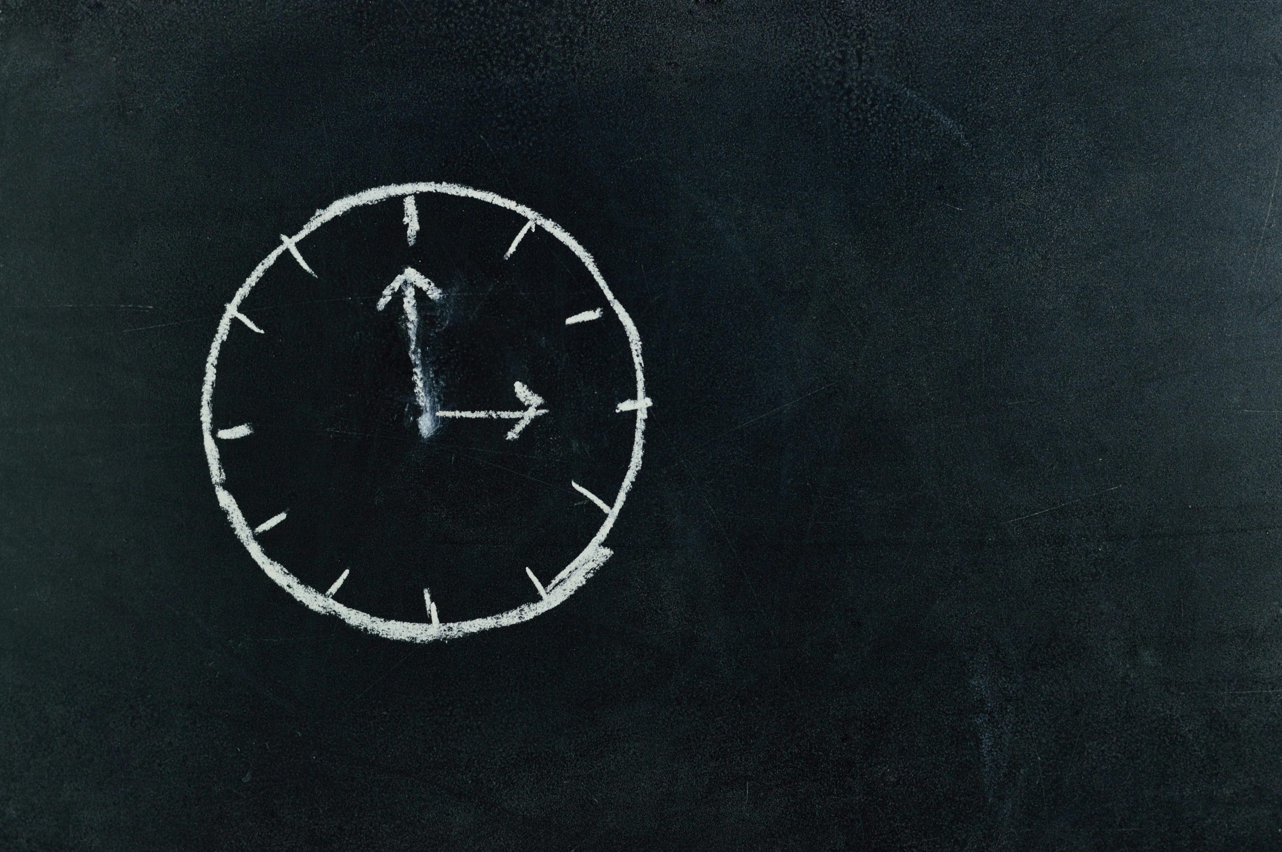 Clock drawn on chalkboard symbolizing time management and boundaries for working
