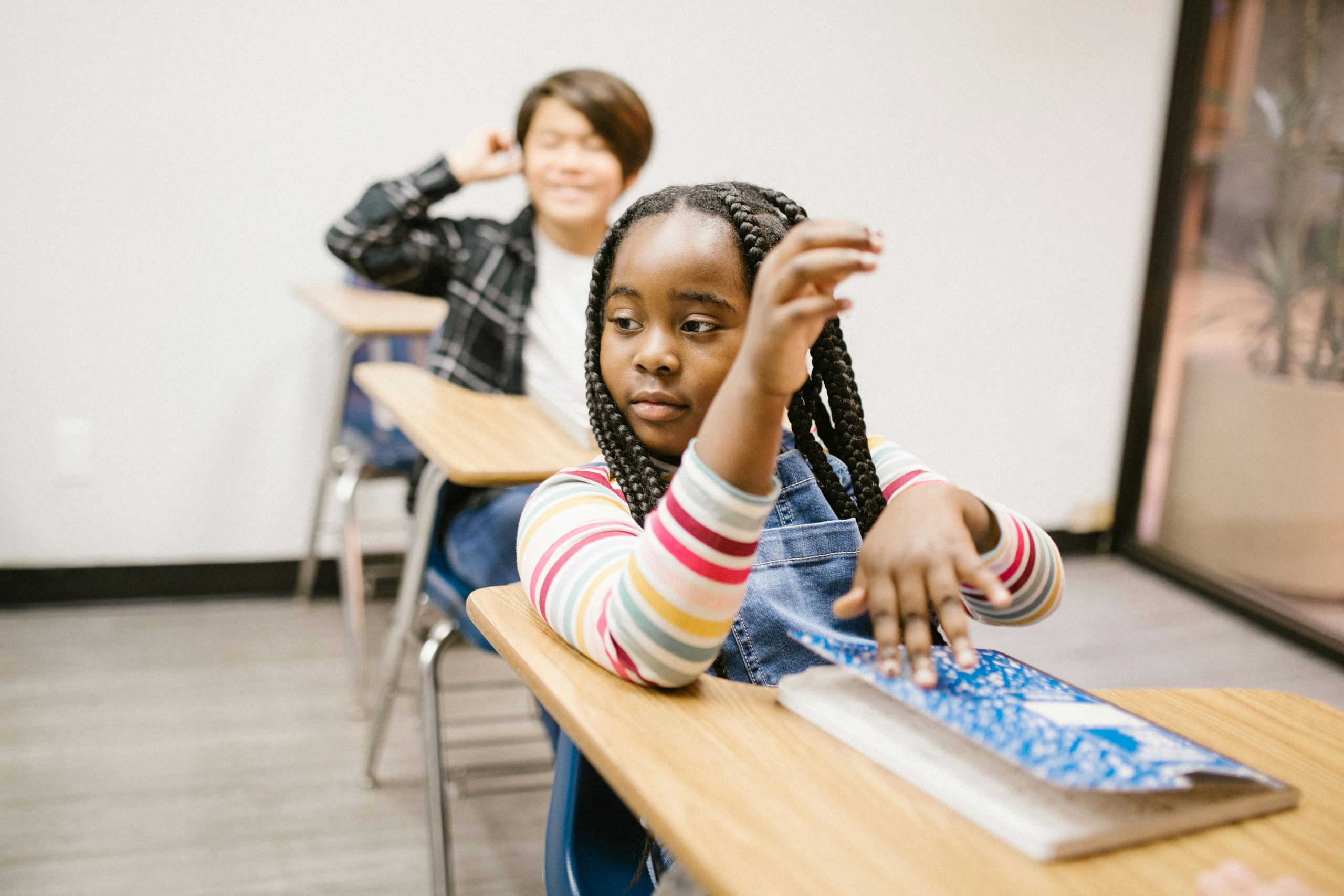 Student looking thoughtful in a classroom during a lesson on fairness and differentiation.